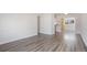 Open-concept living space featuring sleek flooring and a view into the kitchen area at 3299 S Forest St, Denver, CO 80222