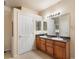 Bathroom with double sink vanity, large mirror and bright vanity lighting at 1801 S Dunkirk St # 205, Aurora, CO 80017