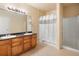 Bathroom featuring a double vanity, a shower stall and a tub with shower at 1801 S Dunkirk St # 205, Aurora, CO 80017