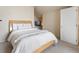 Comfortable bedroom features a cozy bed with a TV on a wall mounted shelf at 1801 S Dunkirk St # 205, Aurora, CO 80017