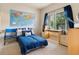 Bedroom features a blue bed, large map, and desk with natural light from the sliding glass door at 1801 S Dunkirk St # 205, Aurora, CO 80017