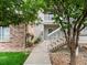 Exterior shot of a charming two-story home with a combination of brick and light stucco at 1801 S Dunkirk St # 205, Aurora, CO 80017