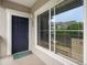 Charming front entrance with a navy blue door and green welcome mat at 1801 S Dunkirk St # 205, Aurora, CO 80017