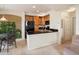 Kitchen features a black refrigerator, black countertop, and wooden cabinetry at 1801 S Dunkirk St # 205, Aurora, CO 80017
