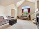 Open living room featuring large windows with red curtains and plush sofas at 1801 S Dunkirk St # 205, Aurora, CO 80017
