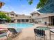 Inviting community pool and spa with lounge chairs and beautiful views of the surrounding buildings at 1801 S Dunkirk St # 205, Aurora, CO 80017