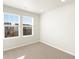 Bright, carpeted bedroom with natural light and neighborhood view at 791 N Tempe St, Aurora, CO 80018