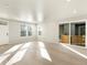 Bright living room featuring light wood floors, recessed lighting, and a sliding glass door to the outside at 791 N Tempe St, Aurora, CO 80018