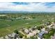 Aerial view showcasing a home nestled in a green landscape with distant mountains, lake and farms at 1264 Banner Cir, Erie, CO 80516