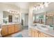 Bright bathroom showcasing double sinks, a soaking tub, and a separate glass-enclosed shower at 1264 Banner Cir, Erie, CO 80516