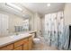Bright bathroom featuring a vanity with sink, toilet, and tub with shower and patterned curtain at 1264 Banner Cir, Erie, CO 80516