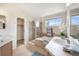 Bright bathroom showcasing double sinks, a soaking tub, and a separate glass-enclosed shower at 1264 Banner Cir, Erie, CO 80516