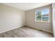 Well-lit bedroom featuring wood-look flooring and a bright window view at 1264 Banner Cir, Erie, CO 80516