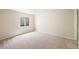 Neutral bedroom space with a large window bringing in lots of natural light at 1264 Banner Cir, Erie, CO 80516