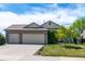 Well-maintained single-Gathering home with a three-car garage and manicured lawn in a suburban neighborhood at 1264 Banner Cir, Erie, CO 80516