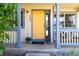 Cozy front porch with a vibrant yellow door, decorative plants, and charming outdoor seating area at 1264 Banner Cir, Erie, CO 80516