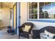 Charming front porch featuring cozy wicker chairs, decorative pillows, and potted plants near the entrance at 1264 Banner Cir, Erie, CO 80516