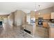 Open-concept kitchen with stainless steel appliances, granite countertops, an island, and bar stool seating at 1264 Banner Cir, Erie, CO 80516