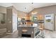 Light-filled kitchen boasts granite counters, wood cabinetry, stainless appliances, and an island with seating at 1264 Banner Cir, Erie, CO 80516