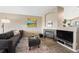 Stylish living area features a fireplace, comfortable seating, and an entertainment center for relaxation and entertainment at 1264 Banner Cir, Erie, CO 80516