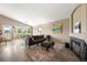 Comfortable living area with a gray sectional sofa, fireplace, and seamless flow into the dining space at 1264 Banner Cir, Erie, CO 80516