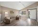 Bright living room features wood floors, a white door, neutral walls, and cozy seating with natural light at 1264 Banner Cir, Erie, CO 80516