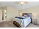 Cozy main bedroom featuring a ceiling fan, a stylish headboard, and charming bedside lamps at 1264 Banner Cir, Erie, CO 80516