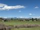 Expansive view of the Rocky Mountains creates a stunning backdrop for a serene, rural landscape at 1264 Banner Cir, Erie, CO 80516