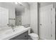 Bathroom features gray vanity, updated fixtures, and a large mirror, providing a clean and modern aesthetic at 17058 Hastings Ct, Parker, CO 80134