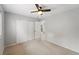 Comfortable bedroom with neutral walls and carpet, ceiling fan, and closet at 17058 Hastings Ct, Parker, CO 80134