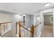Bright upstairs hallway featuring wood trim and access to multiple rooms at 17058 Hastings Ct, Parker, CO 80134