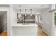 Bright kitchen features gray cabinets, stainless steel appliances, quartz countertops, and hardwood floors at 17058 Hastings Ct, Parker, CO 80134