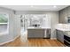 Modern kitchen boasts stainless steel appliances, gray cabinets, and an open layout to the living area at 17058 Hastings Ct, Parker, CO 80134
