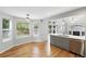 Modern kitchen seamlessly blending into the breakfast nook, with stainless appliances and views of the backyard at 17058 Hastings Ct, Parker, CO 80134