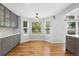 Bright kitchen nook featuring gray cabinets, quartz countertops, and a sunny bay window for dining at 17058 Hastings Ct, Parker, CO 80134