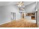 Bright and airy living room boasts hardwood floors and an open floor plan leading to a modern kitchen at 17058 Hastings Ct, Parker, CO 80134