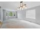 Expansive living room with carpet flooring and multiple windows providing natural light at 17058 Hastings Ct, Parker, CO 80134