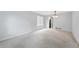 Bright and airy living room with neutral carpet and view into the updated kitchen at 17058 Hastings Ct, Parker, CO 80134