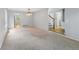 Spacious living room boasts neutral carpet and view into the entryway and kitchen at 17058 Hastings Ct, Parker, CO 80134