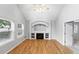 Cozy living room showcasing hardwood floors, a fireplace with custom built-ins, and abundant natural light at 17058 Hastings Ct, Parker, CO 80134