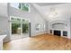 Bright living space with hardwood floors, a fireplace, and access to the backyard deck through sliding glass doors at 17058 Hastings Ct, Parker, CO 80134