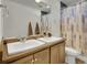 A well-lit bathroom with double sinks and a shower/tub combo at 19155 Robins Dr, Denver, CO 80249