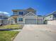 Charming two-story home featuring a spacious driveway and three car garage at 19155 Robins Dr, Denver, CO 80249