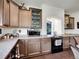 This kitchen has stained wood cabinets, granite countertops, stainless steel appliances and hardwood floors at 19155 Robins Dr, Denver, CO 80249