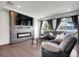 Cozy living room showcasing a modern fireplace and hardwood flooring at 19155 Robins Dr, Denver, CO 80249