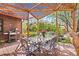 Outdoor patio area with a glass table, wrought iron chairs, and a lovely pergola at 1439 S Emerson St, Denver, CO 80210