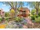Beautiful backyard with a brick path, mature trees, shrubs and lush landscaping at 1439 S Emerson St, Denver, CO 80210