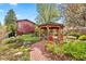 Lush backyard featuring a gazebo, beautiful garden, and wood pergola at 1439 S Emerson St, Denver, CO 80210