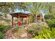 Secluded backyard gazebo with seating, surrounded by lush gardens at 1439 S Emerson St, Denver, CO 80210