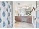 Modern bathroom with double sink vanity, spacious mirror, and stylish shower curtain at 1439 S Emerson St, Denver, CO 80210